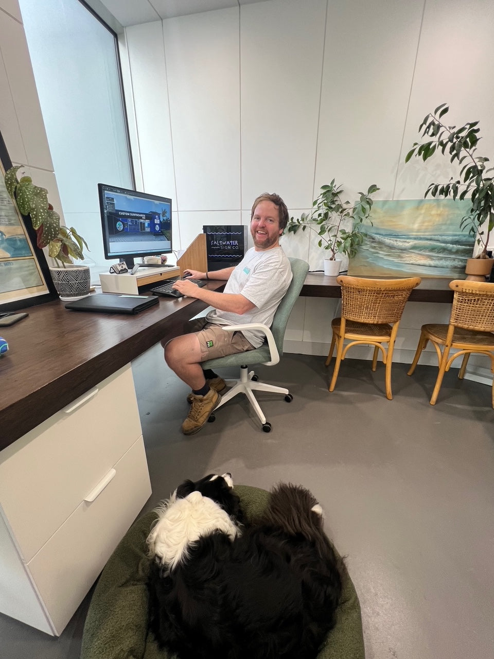 Portrait photo Of Head Signwriter Mark Howlett from Saltwater Sign Co sitting at desk