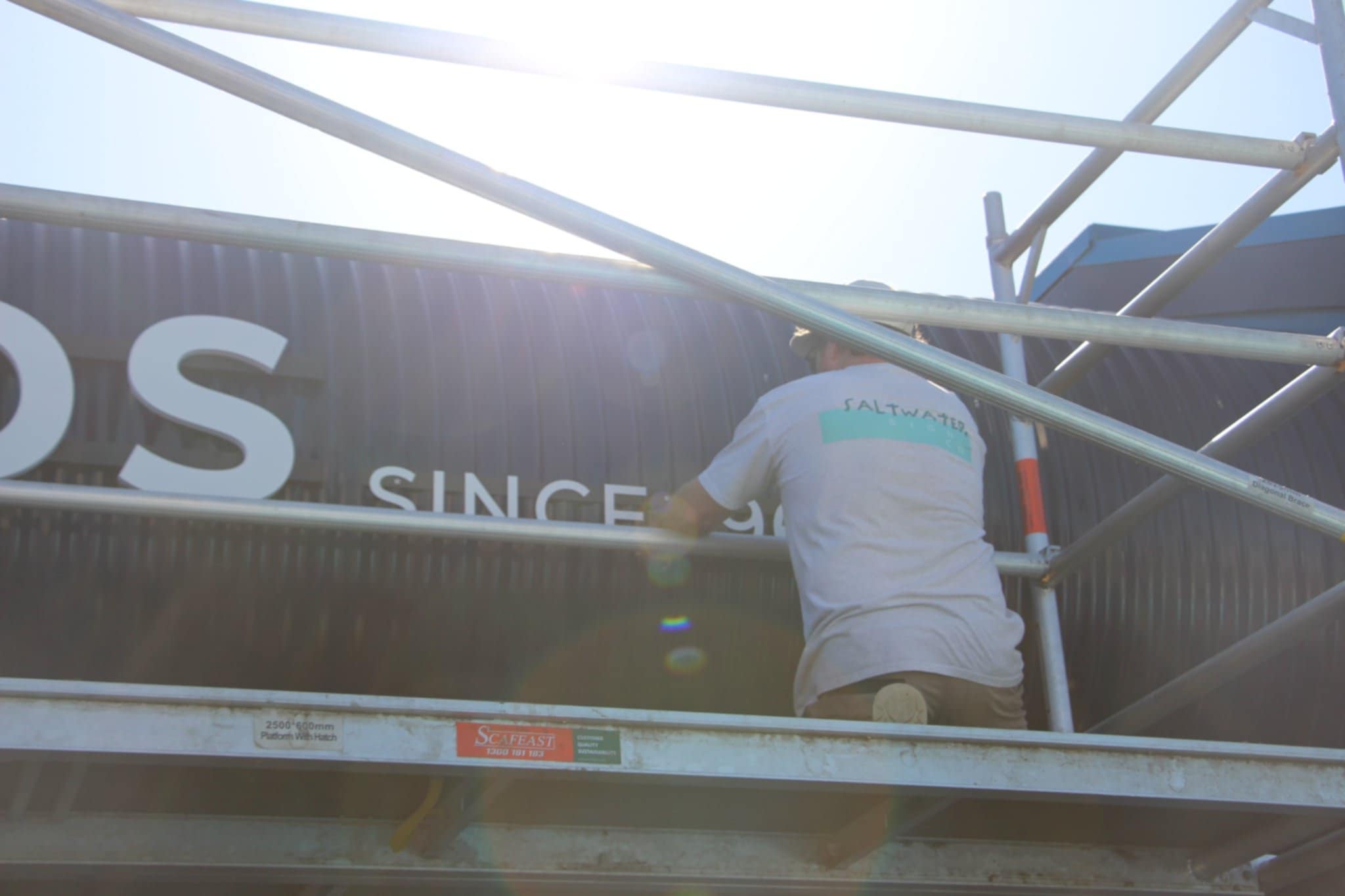 Sign_being_installed_by_Mark_Howlett_on_Scaffold_by_Saltwater_Sign_Co._3.jpg