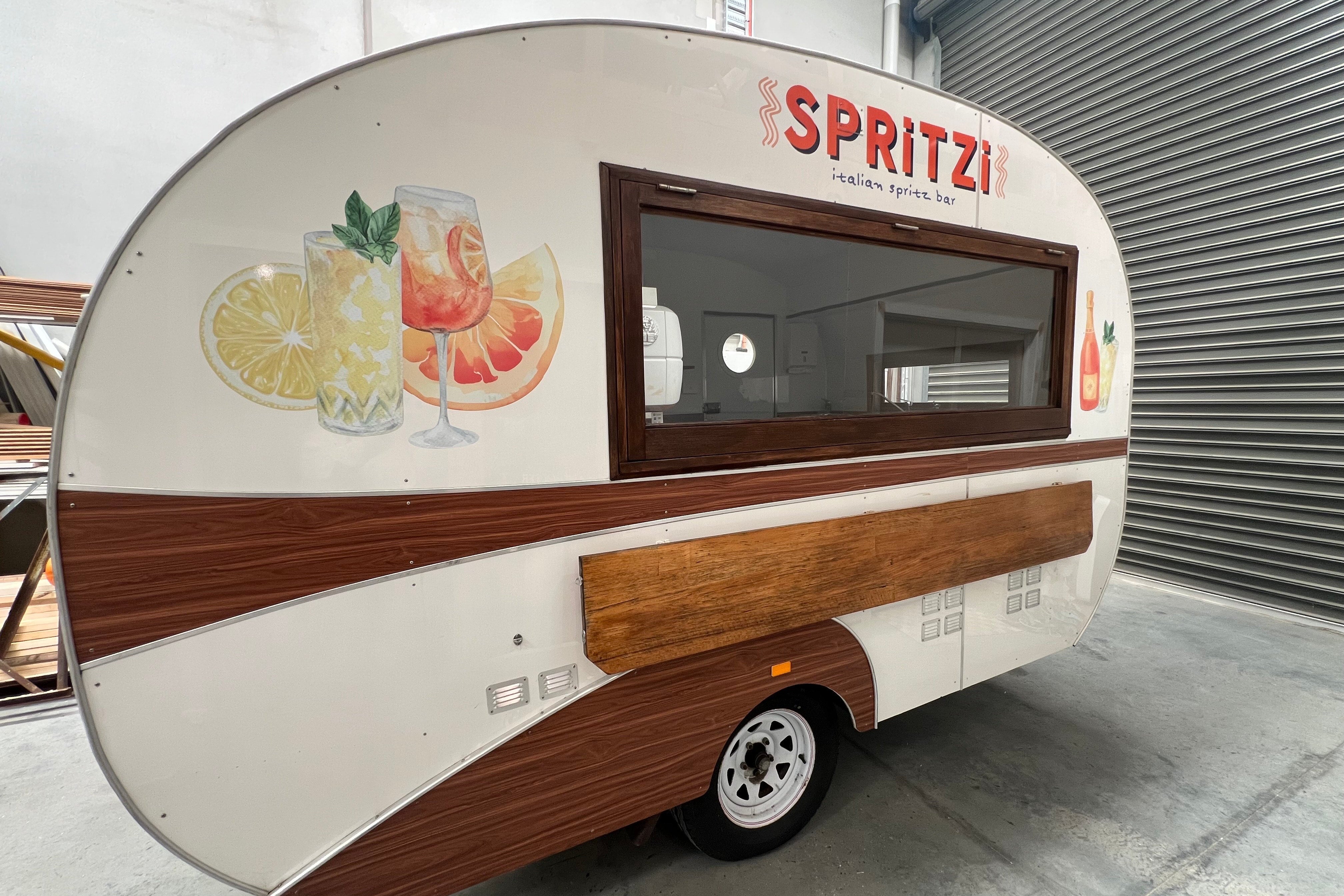 Spritzi Caravan decal signage in the factory by Saltwater Sign Co.