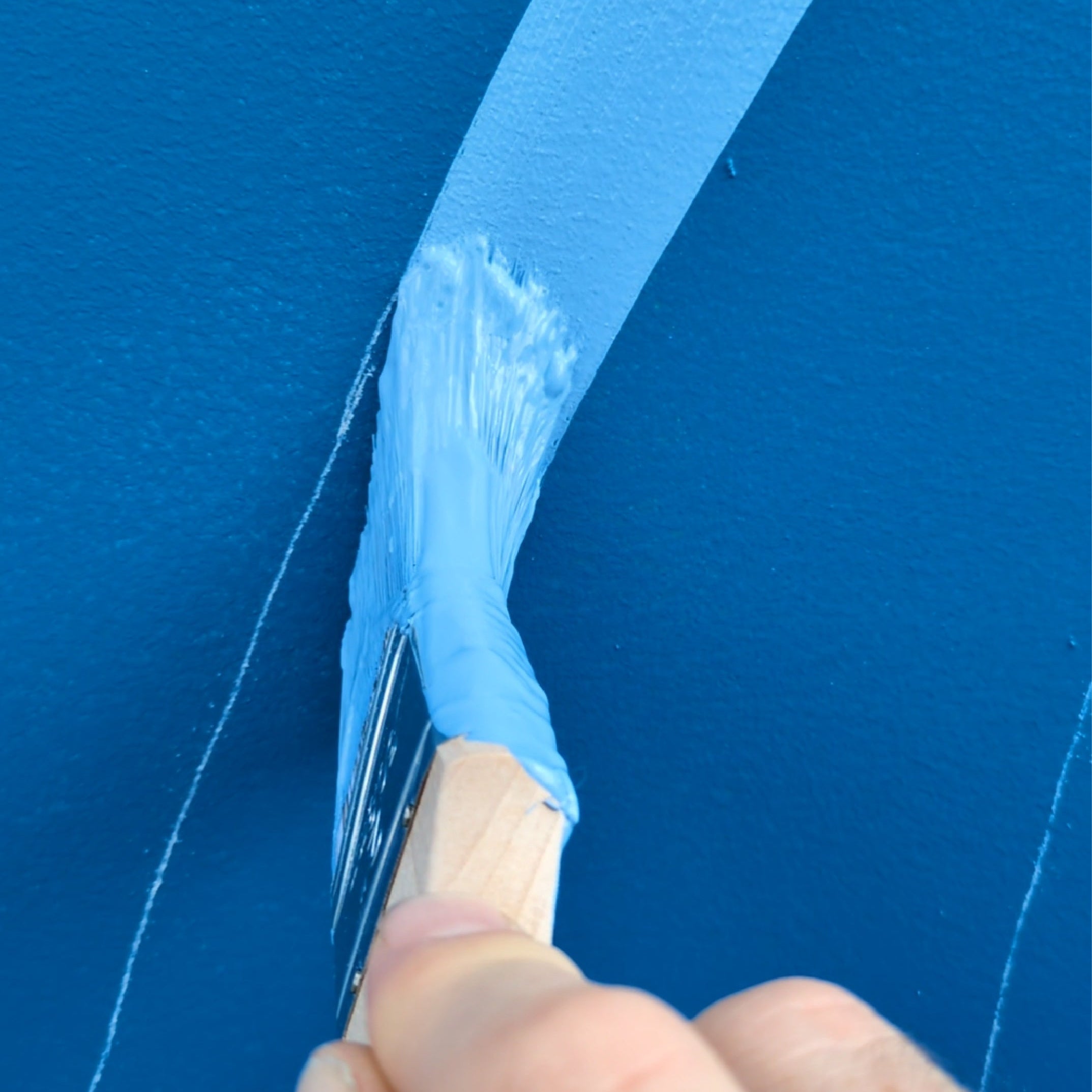 Traditional hand brushed close up of hand and brush by Saltwater Sign Co.