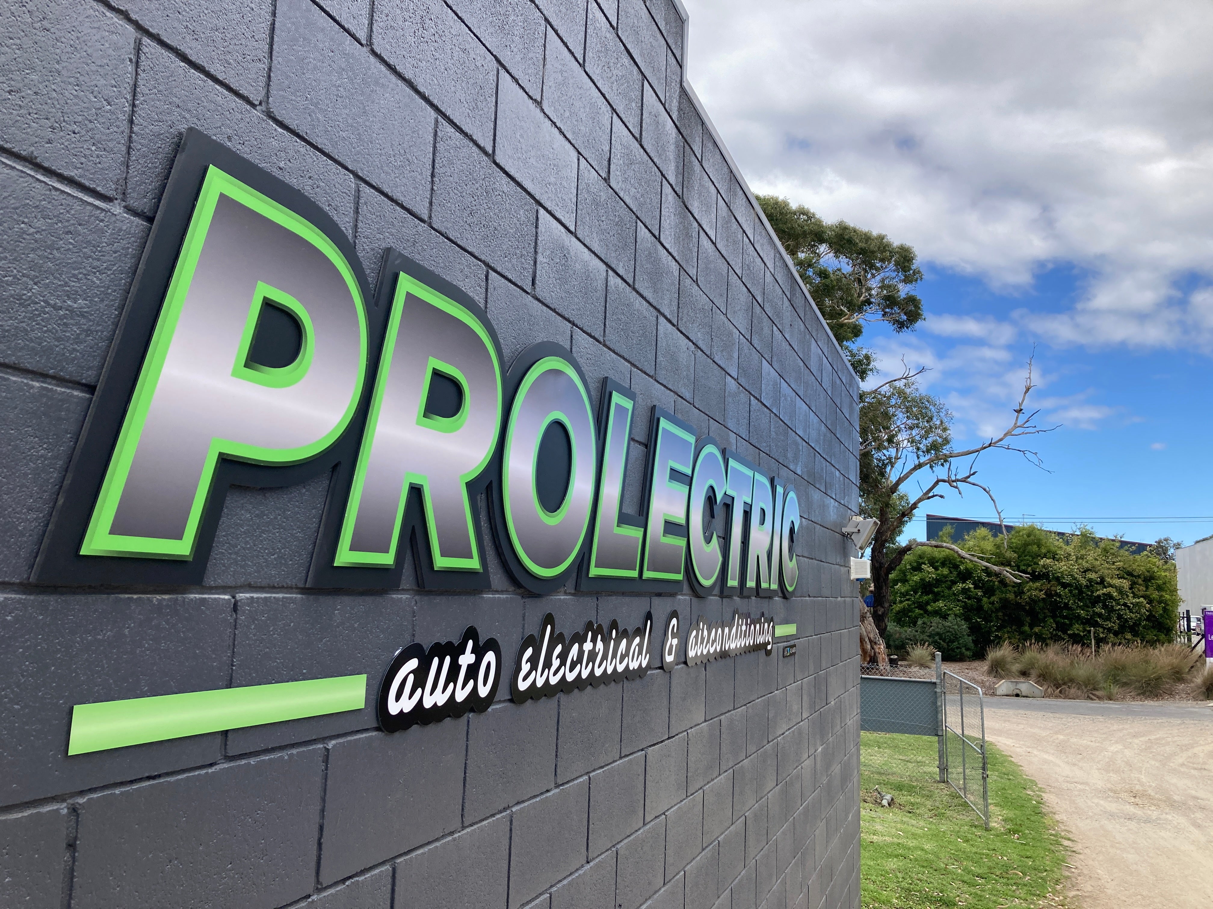 b2b factory shop exterior wall signage on brick work zoomed out